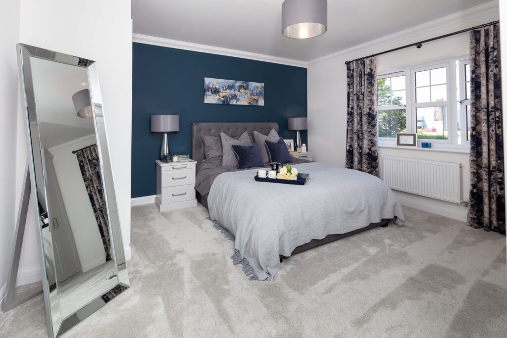 Stylish master bedroom with deep blue feature wall