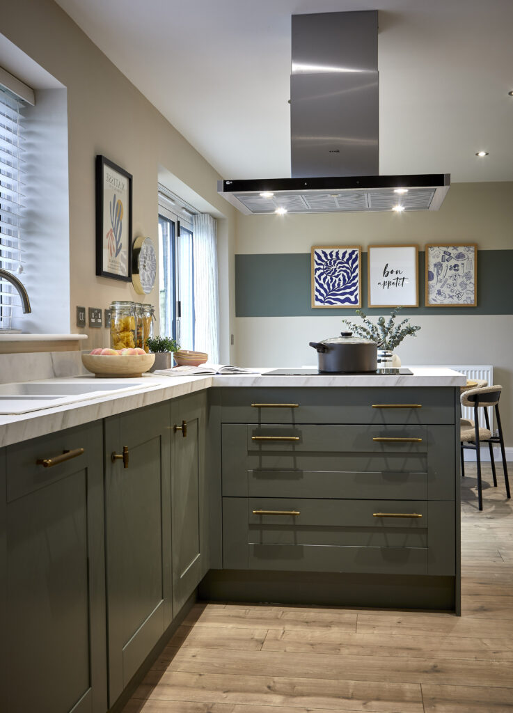 Kitchen area of a Crayke home, white countertop, dark green cupboards