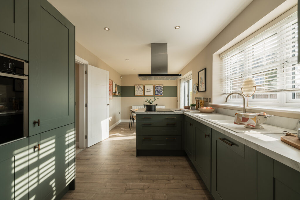 Modern kitchen with large windows inside a Beal home.